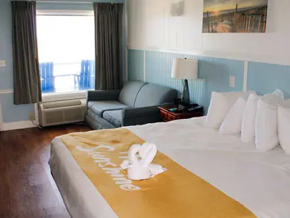 King bed and sofa in an oceanfront guest room at Blue Heron Motel